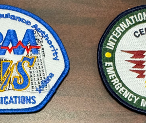 100-TRAA-COMMUNICATIONS Sew 2 Emblems:  Left Shoulder: TRAA EMS COMM-7. Right Shoulder: TRAA INTERNATIONAL ACADEMY